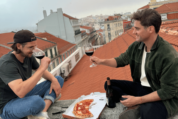 Red Wine Glasses and bottles with wine lovers on a roof.